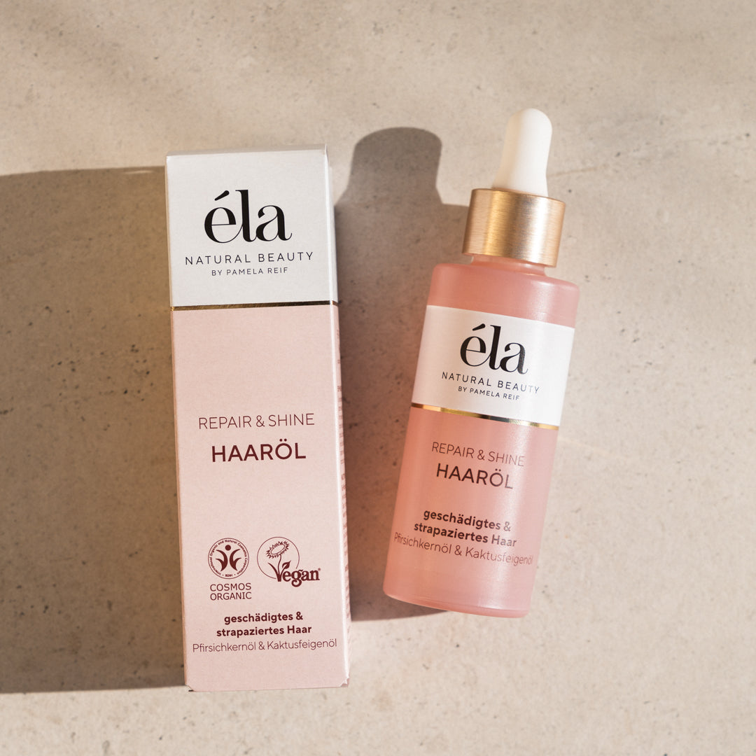 Natürliches Haaröl von Naturally Pam, éla Natural Beauty, in einer Flasche mit Pumpverschluss, für glänzendes und gepflegtes Haar.